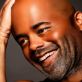 uncovering darius rucker's net worth: a look at his career and private life 6 a person smiling, with a hand resting on their head.