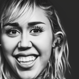 A person with long hair smiles widely, displaying upper teeth. The image is in black and white, focusing on the face and expression.