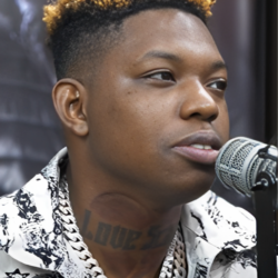 Yung Bleu speaking into a microphone during a 2021 HOTSPOTATL interview