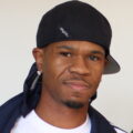 Chamillionaire wearing a black cap and white jacket at TechCrunch August Capital in July 2008