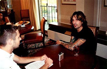 tommy lee net worth: $70m estimate, mötley crüe & family 1 tommy lee seated on the right in an archival 2002 photograph by freschwill