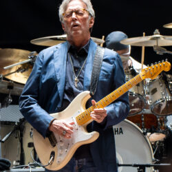 Eric Clapton performing with a guitar at the Royal Albert Hall in 2023