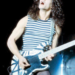 Eddie Van Halen performing with his striped guitar at the New Haven Coliseum in September 1978