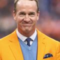 peyton manning net worth: nfl pay, omaha & family 4 peyton manning in a gold jacket in an archival 2021 photograph